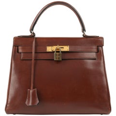 HERMES c.1964 "Kelly" 28 cm Sac à main en cuir de veau marron avec poignée supérieure