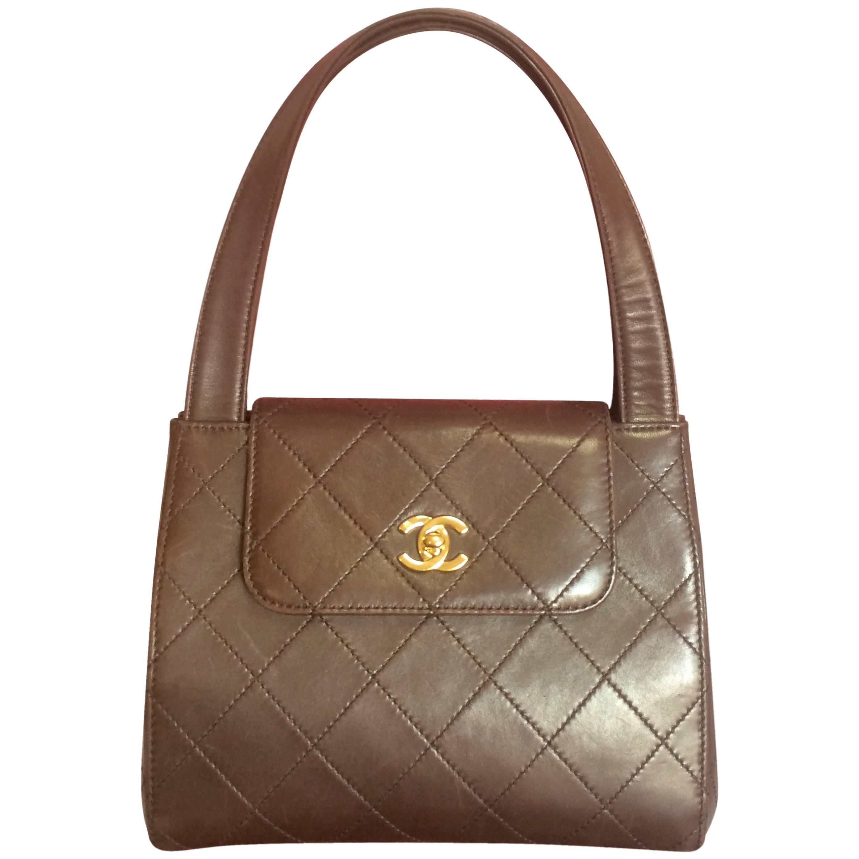 Vintage CHANEL chocolate brown leather trapezoid shape handbag with golden CC. For Sale