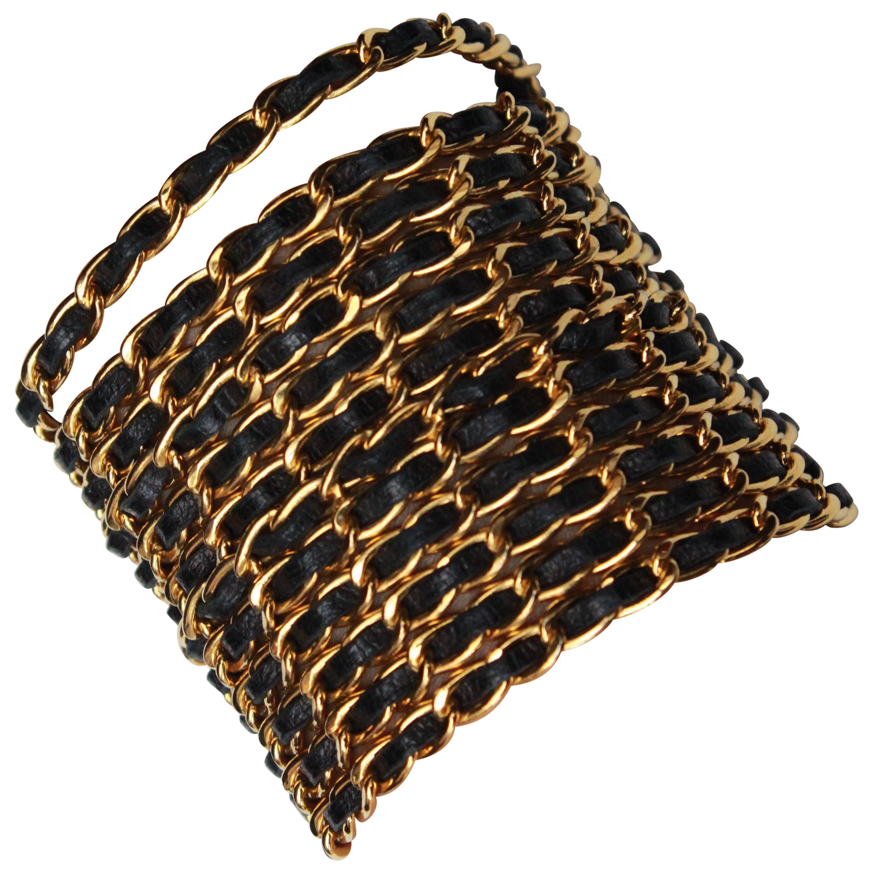Chanel wide bracelet composed of gilded metal chains with black leather, 1990s 