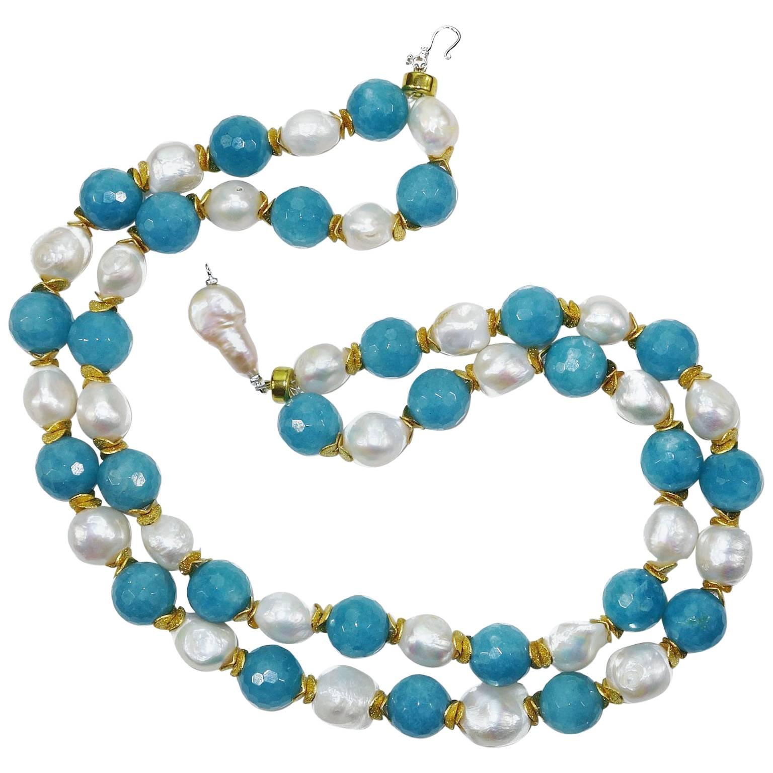 Double strand necklace of faceted (13mm) agate balls and irregular pearls separated by frosted gold tone spacers. Beautiful irregular pearl closure that can be focal secures the necklace. 18.5inches in length. Pearl is the June birthstone.
