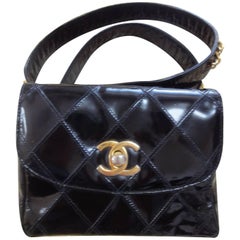 Retro CHANEL black patent enamel waist purse, fanny pack with gold chain belt.