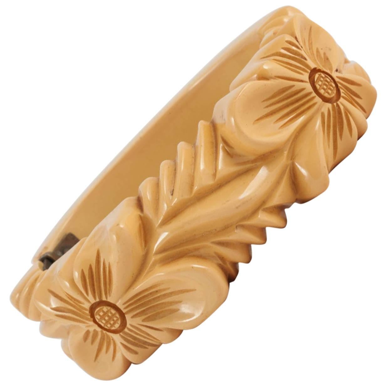 A carved cream bakelite "snapper" bangle/bracelet, with floral motif, 1930s For Sale