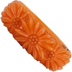 Vintage A carved amber Bakelite 'clamper' bracelet, with floral motif,  USA, 1930s