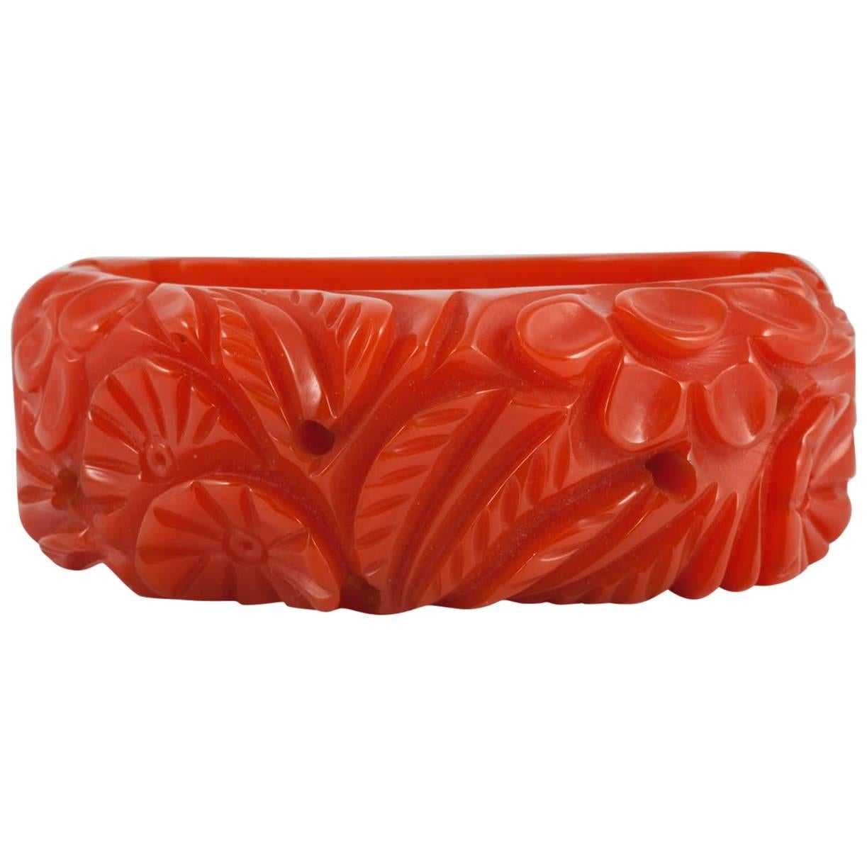 Carved orange bakelite 'clamper' bangle, USA, 1930s. For Sale