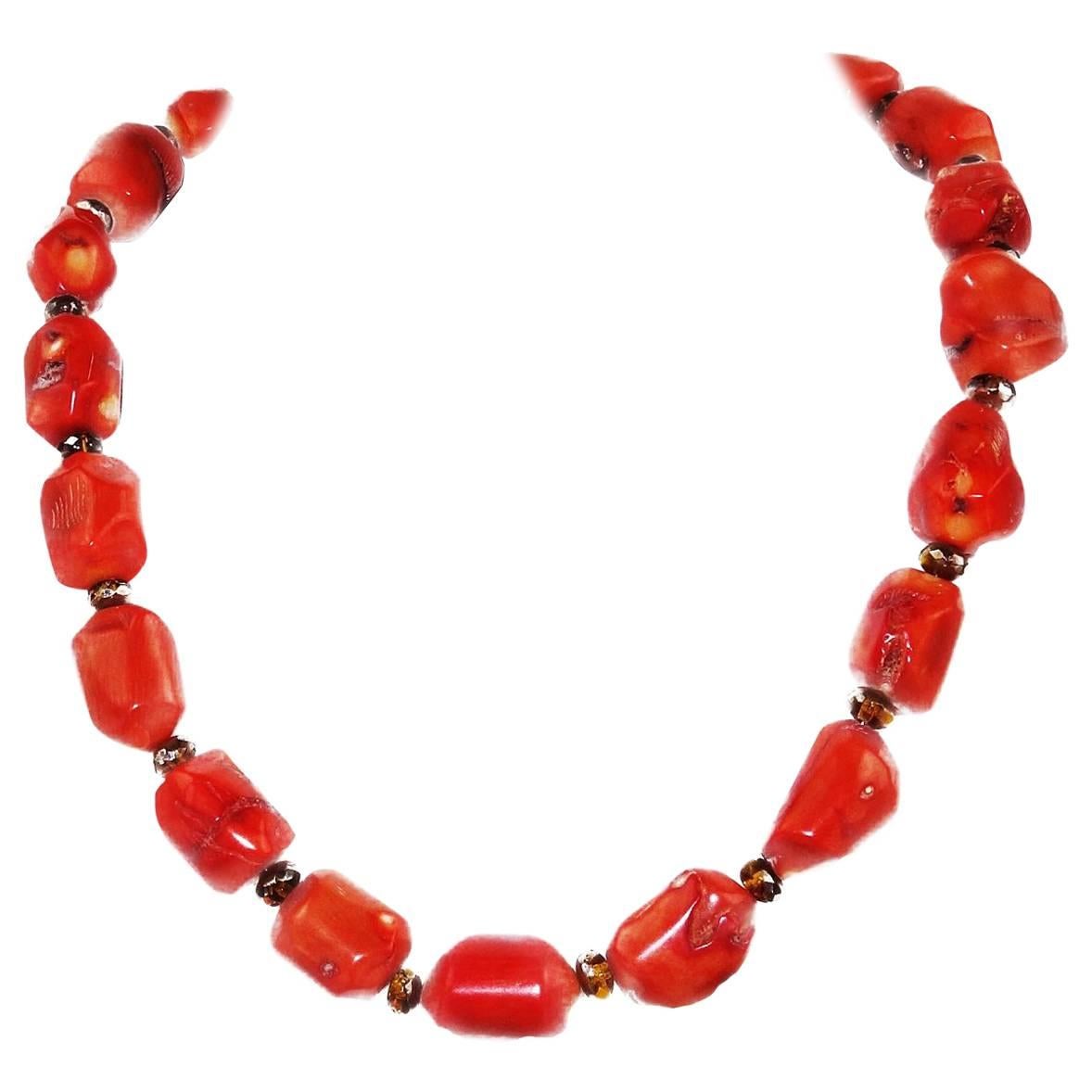 Unique orange polished bamboo coral necklace of slightly irregular tubes. (15x13mm), accented with sparkly gold spacers and a gold-tone hook clasp. Handmade perfection to complete your fall/winter ensembles. Length: 19.5in Clasp: Gold-tone, hook. 
