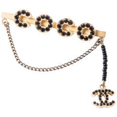 Chanel Matte Gilded Metal and Black Rhinestones "Coco" Brooch