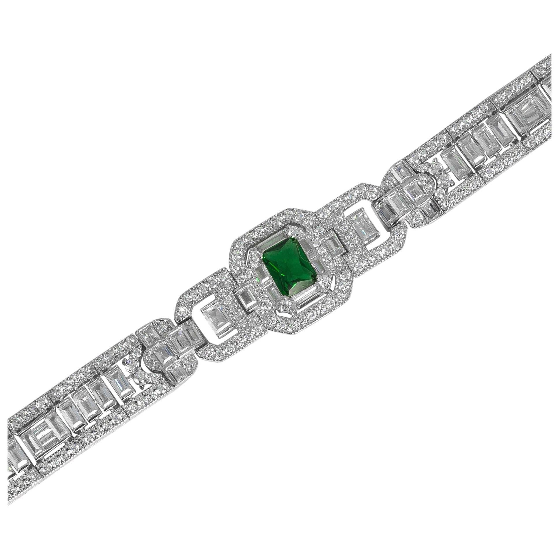 Art Deco style diamond emerald costume jewelry  bracelet hand made and hand cut cubic zirconia hand set in non  tarnish rhodium sterling silver. Baguettes running through the center edged with round stones all flexible center set art deco motif with