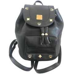 Used MCM black backpack with golden studded motifs, by Michael Cromer