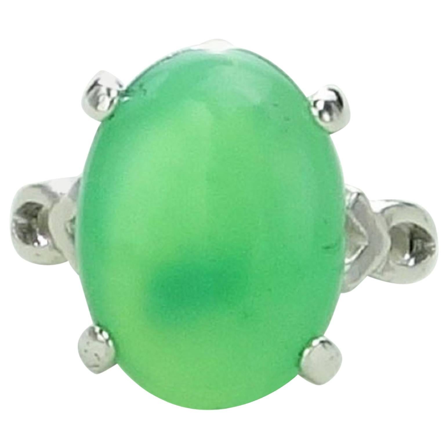 Custom made, warm, glowing, Green Chrysoprase oval cabochon set in Sterling Silver ring with detail on the shank.  This unique Chrysoprase measures 16x12MM and the ring is a sizable 7.  
More from this seller by entering gemjunky in the 1stdibs