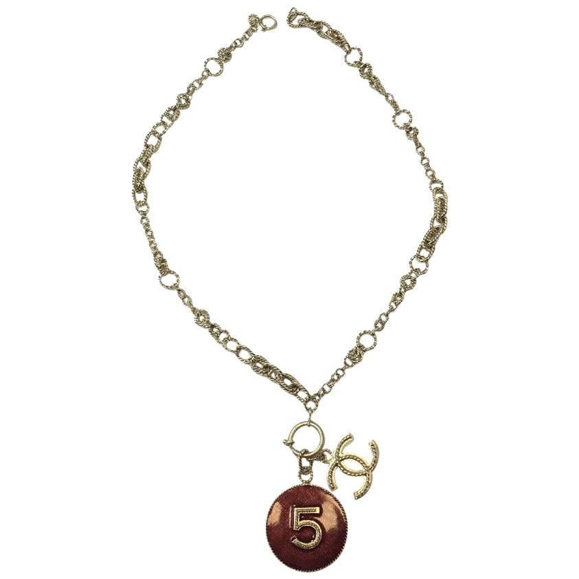 CHANEL Pendant N°5 and CC Necklace in Gilded Metal and Burgundy Resin