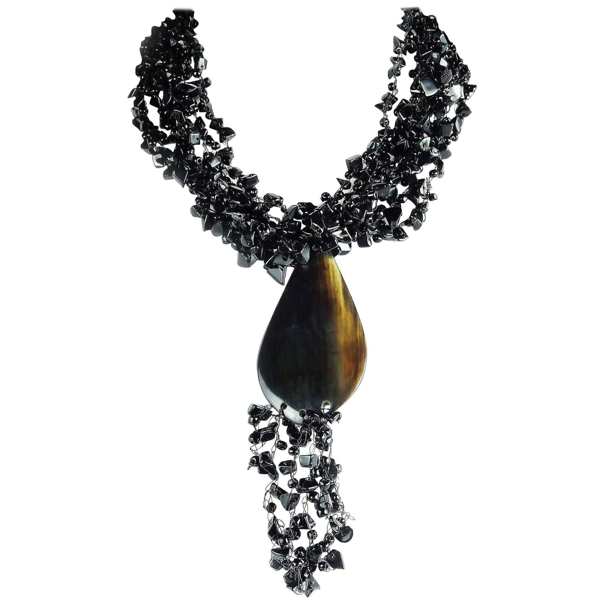 Eight strands of Polished Onyx chips in 18 inch Necklace culminating in horn pendant and tassels of more chips. The Onyx chips are loosely woven together to create an airy look. Statement in Black! 