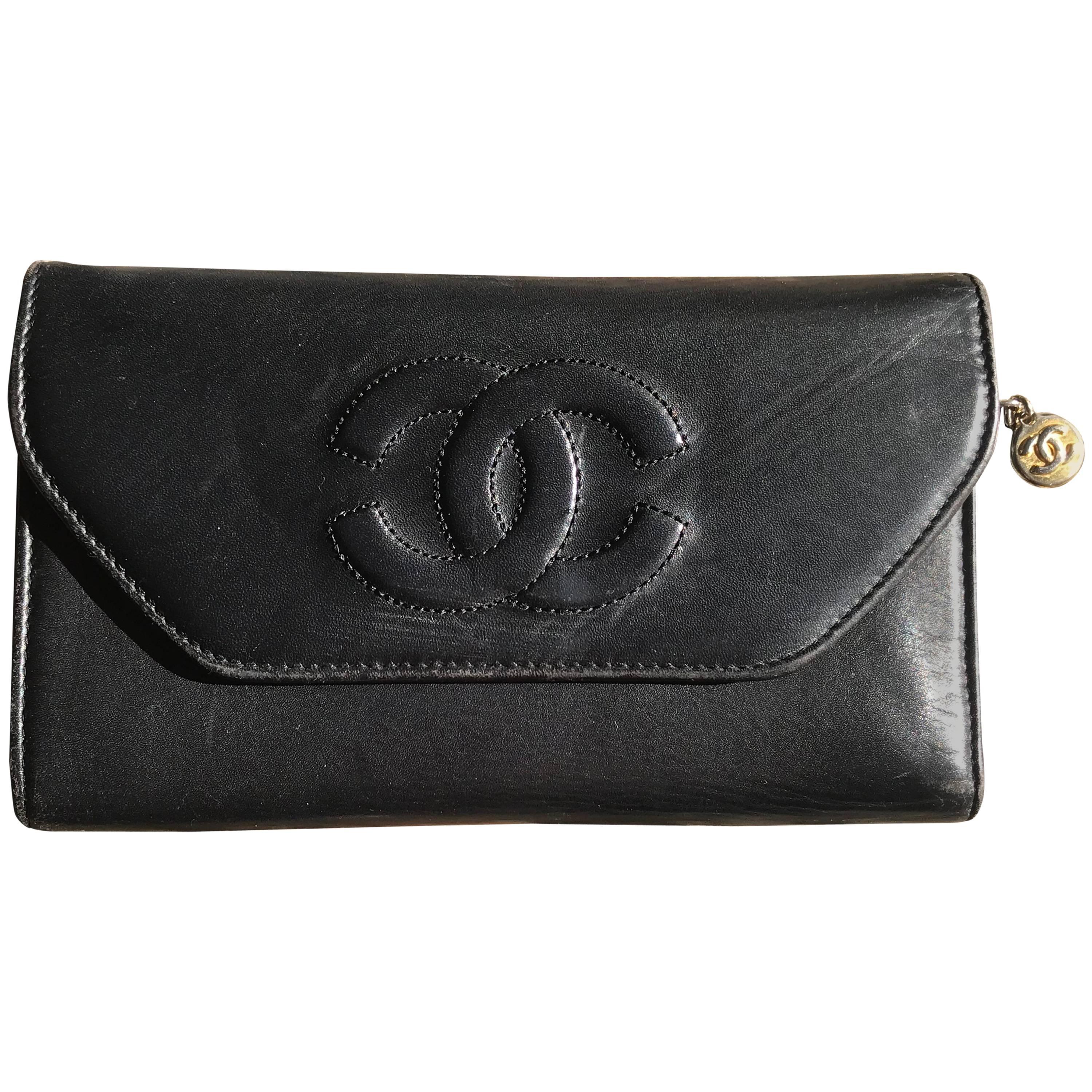 Vintage CHANEL black leather wallet with large CC stitch mark. 