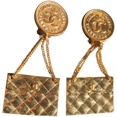 Vintage CHANEL classic 2.55 bag design dangling earrings with CC mark.