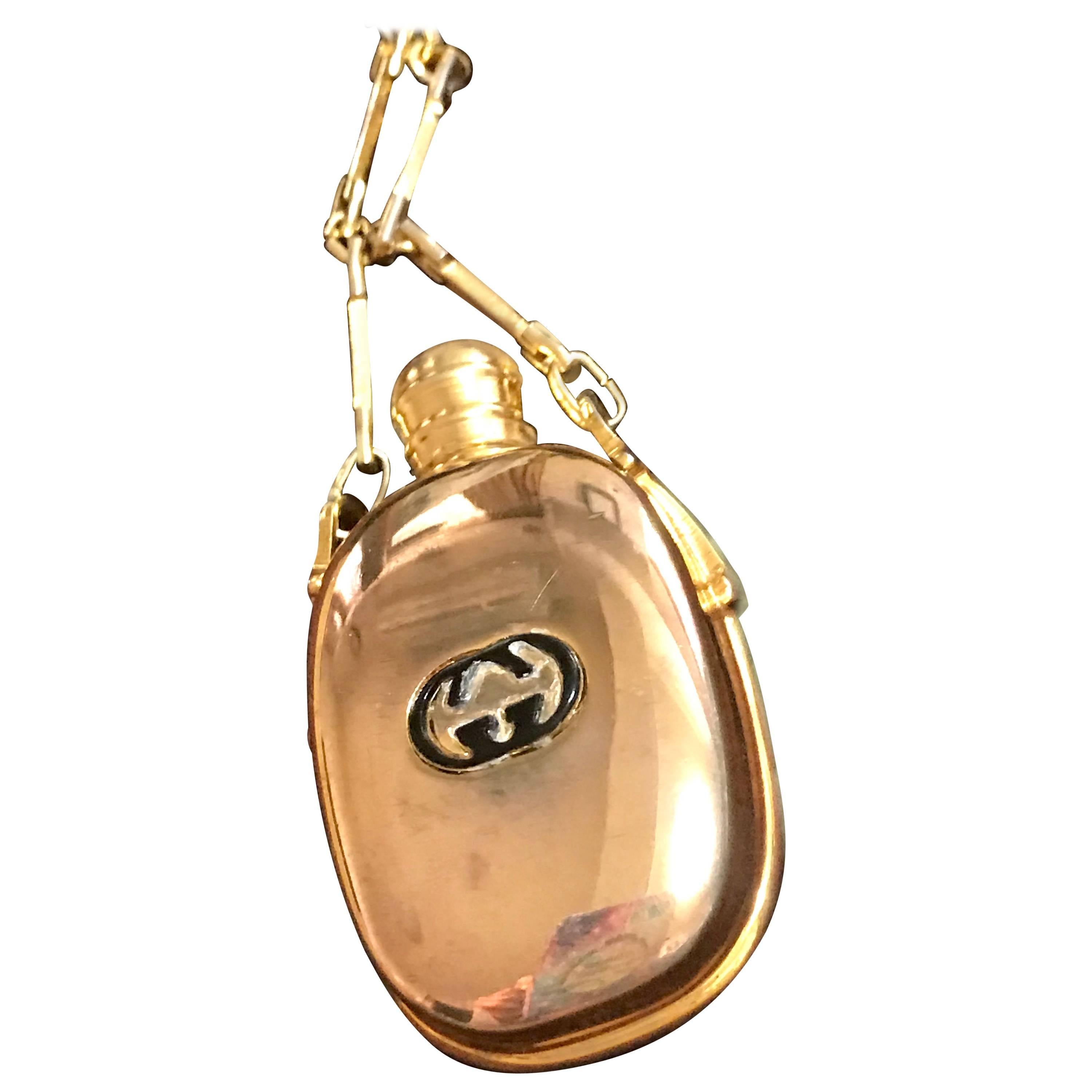 Vintage Gucci golden perfume bottle necklace with logo mark on top. 