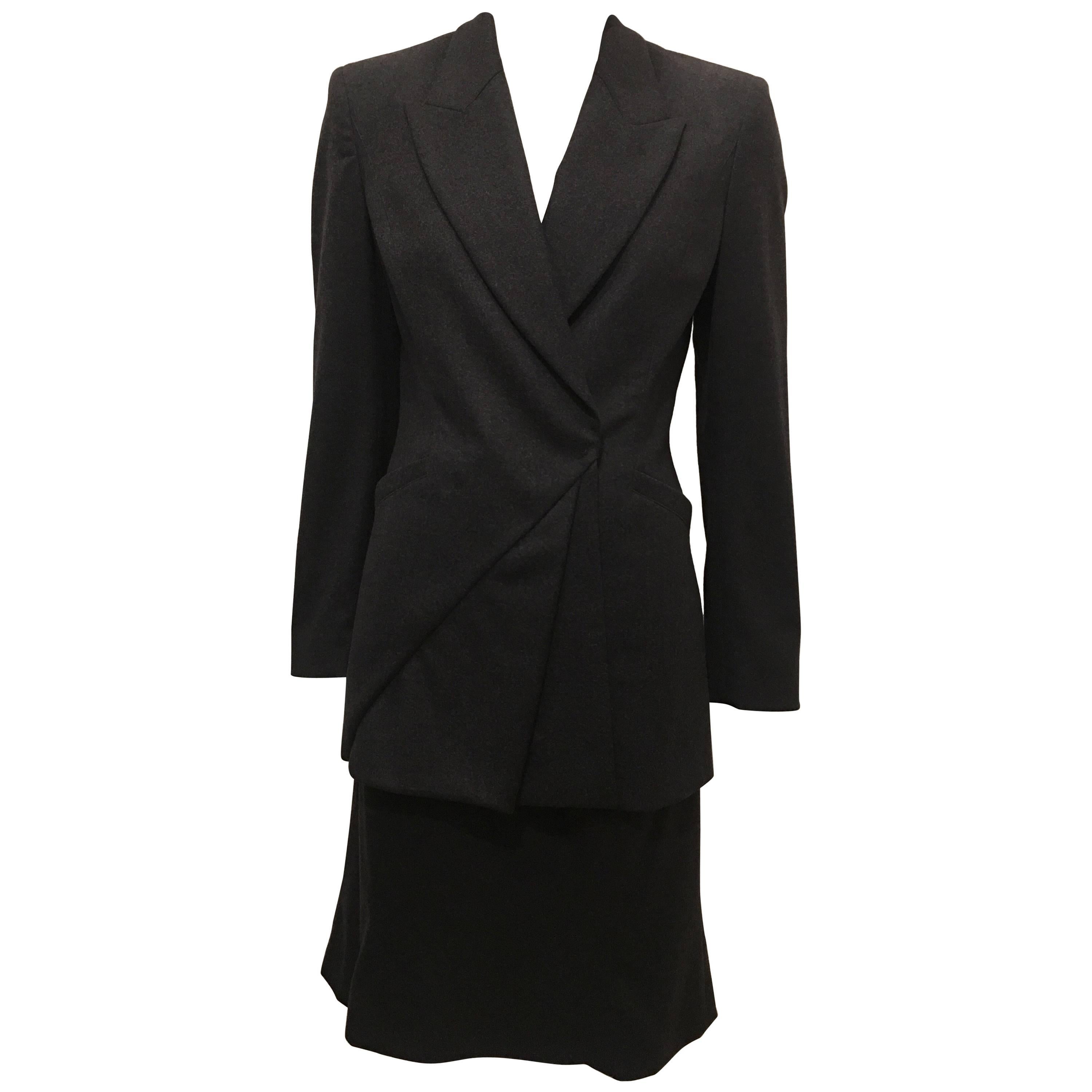 Dark gray wool suit skirt from Claude Montana. Zips at the left side. Straight, hits at mid thigh. Made in Italy. Perfect for winter workwear or everyday wear. Neutral color will go with everything and simple design allows for it to be dressed up or