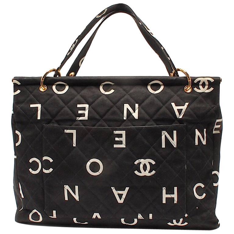 Vintage CHANEL black fabric canvas large tote bag with white Chanel CC prints. For Sale