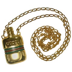 MINT. Vintage Gucci golden mini perfume, eau de cologne bottle necklace.
