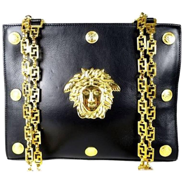 Vintage Gianni Versace black leather tote bag with big golden medusa motif. Rare For Sale
