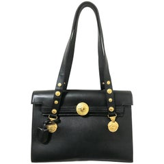 Vintage Gianni Versace black Kelly style shoulder tote bag with golden medusa.