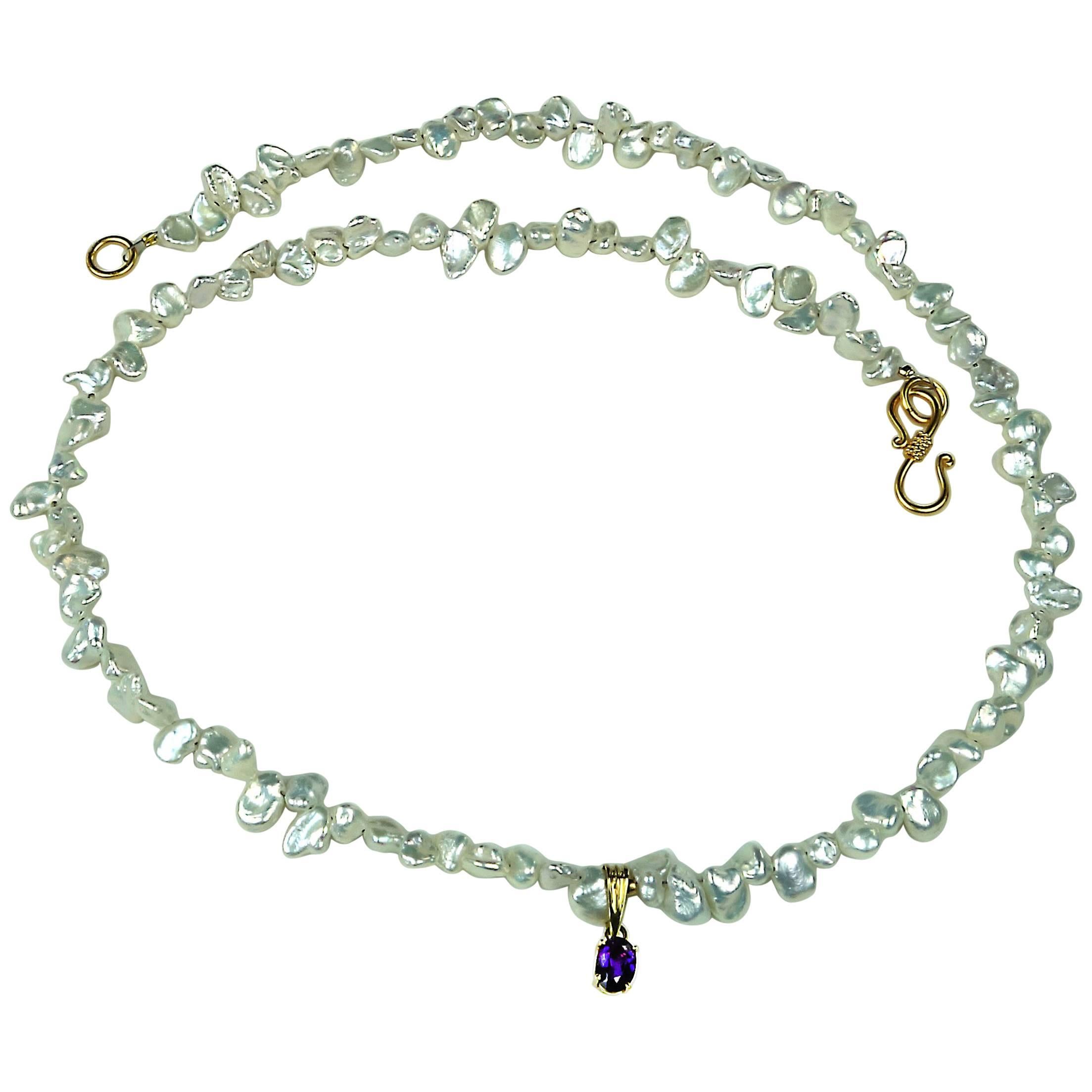 Lovely delicate iridescent 5mm Freshwater 18in Pearl necklace with a pendant of 5x3mm deep Purple brazilian Amethyst set in 18k Yellow gold. The clasp in a vermeil S hook. Pearl in the traditional June birthstone.