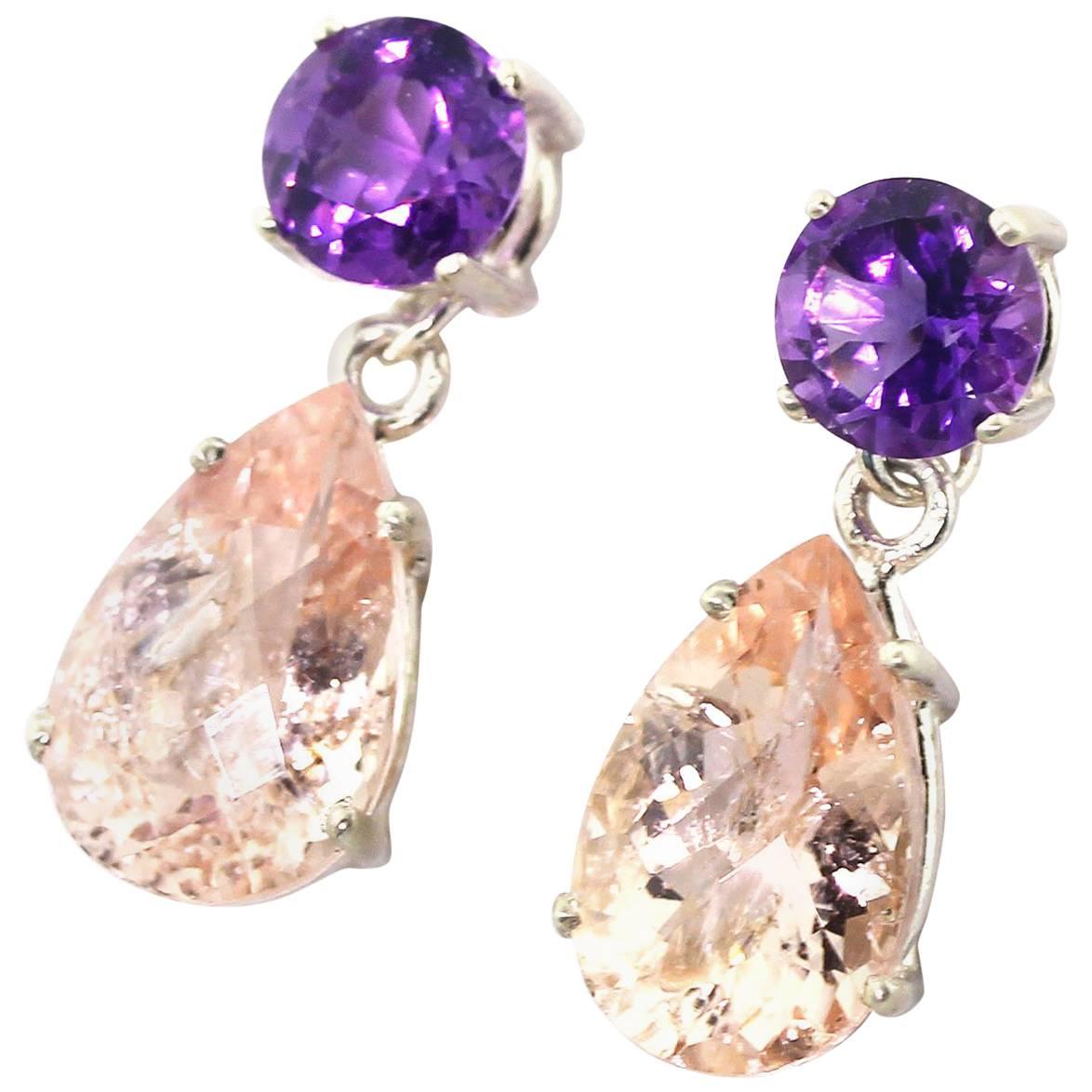 Glittering 15.36 carats of checkerboard gem cut Krinkle pink tone Morganite dangle elegantly from these brilliant 2.41 carats Amethysts set in Sterling Silver stud earrings.  They hang approximately 1 inch long and go directly from daytime to