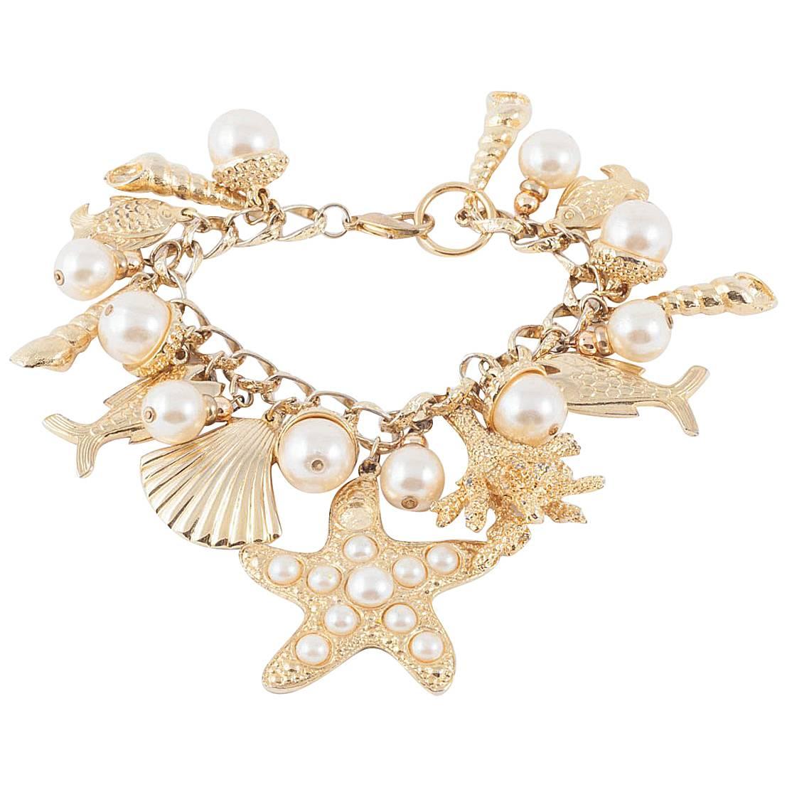 Large gilt metal and paste pearl 'seashell' charm bracelet, USA, 1960s ...