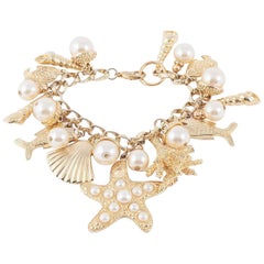 Large gilt metal and paste pearl 'seashell' charm bracelet, USA, 1960s