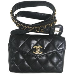 Vintage CHANEL black lamb waist bag, fanny pack with golden chain belt and CC.
