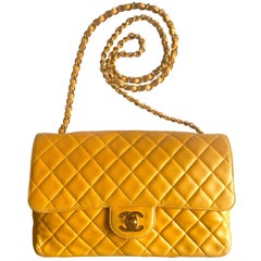 Vintage Chanel classic 2.55 yellow lamb leather shoulder bag with golden CC.