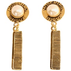 Vintage Moschino Bijoux gilt earrings with comb motif, 1990s
