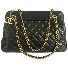 Vintage CHANEL black lambskin large tote bag with gold tone chains and jumbo CC.