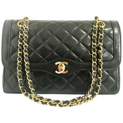 Vintage Chanel black 2.55 classic double flap bag with gold and silver CC motif.