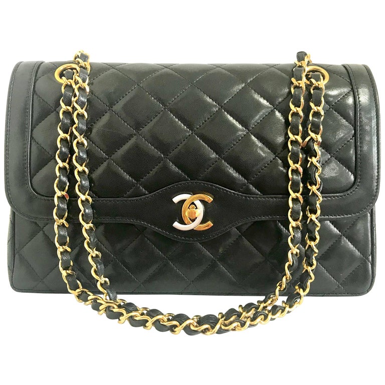 Vintage Chanel black 2.55 classic double flap bag with gold and silver CC  motif.