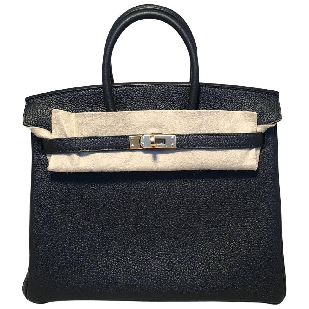 Absolutely Stunning Hermes Black Clemence 25cm GHW Birkin Bag in like new excellent condition.  Black clemence leather exterior trimmed with gold palladium hardware that still has the plastic protection covering. Signature double strap twist top