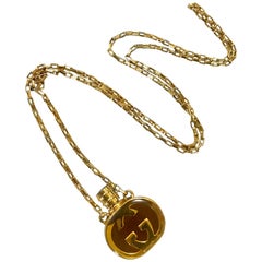 Gucci Vintage gold / brown round shape perfume bottle necklace with brown motif 