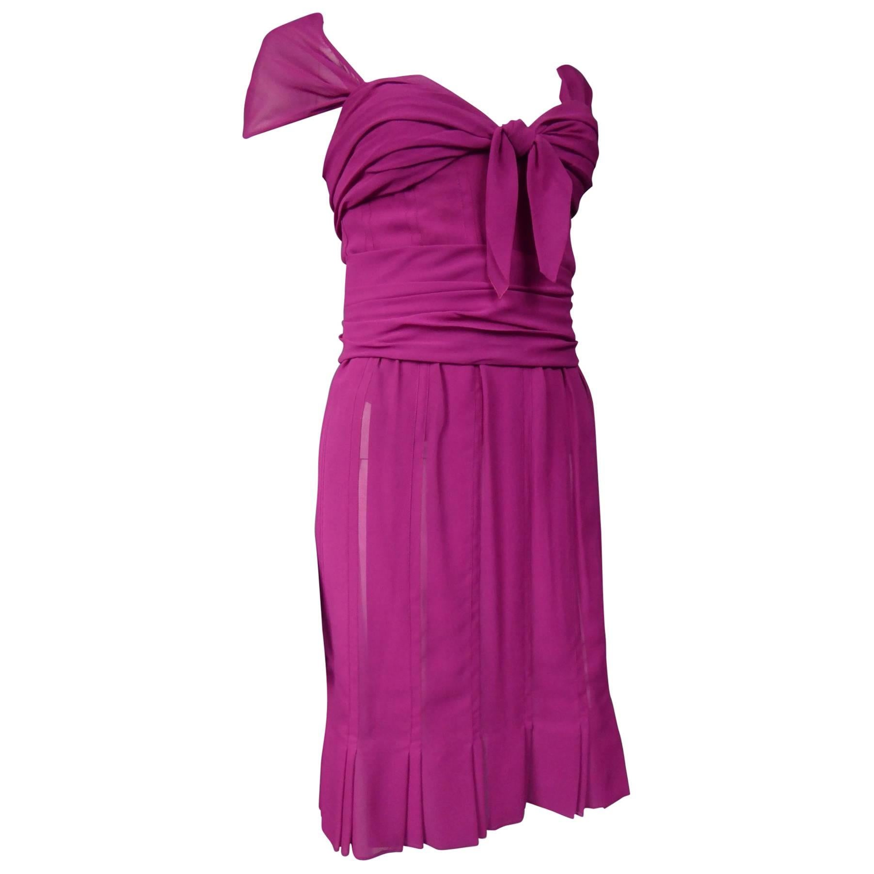 Circa 1989 - 1990
France
Cocktail dress in raspberry pink silk muslin from Dior-Gianfranco Ferré. Bodice inspired by 1940's Fashion, fully corseted and lined with matching chiffon silk. Bodice sheathed to the hips, boned and reinforced on the chest.