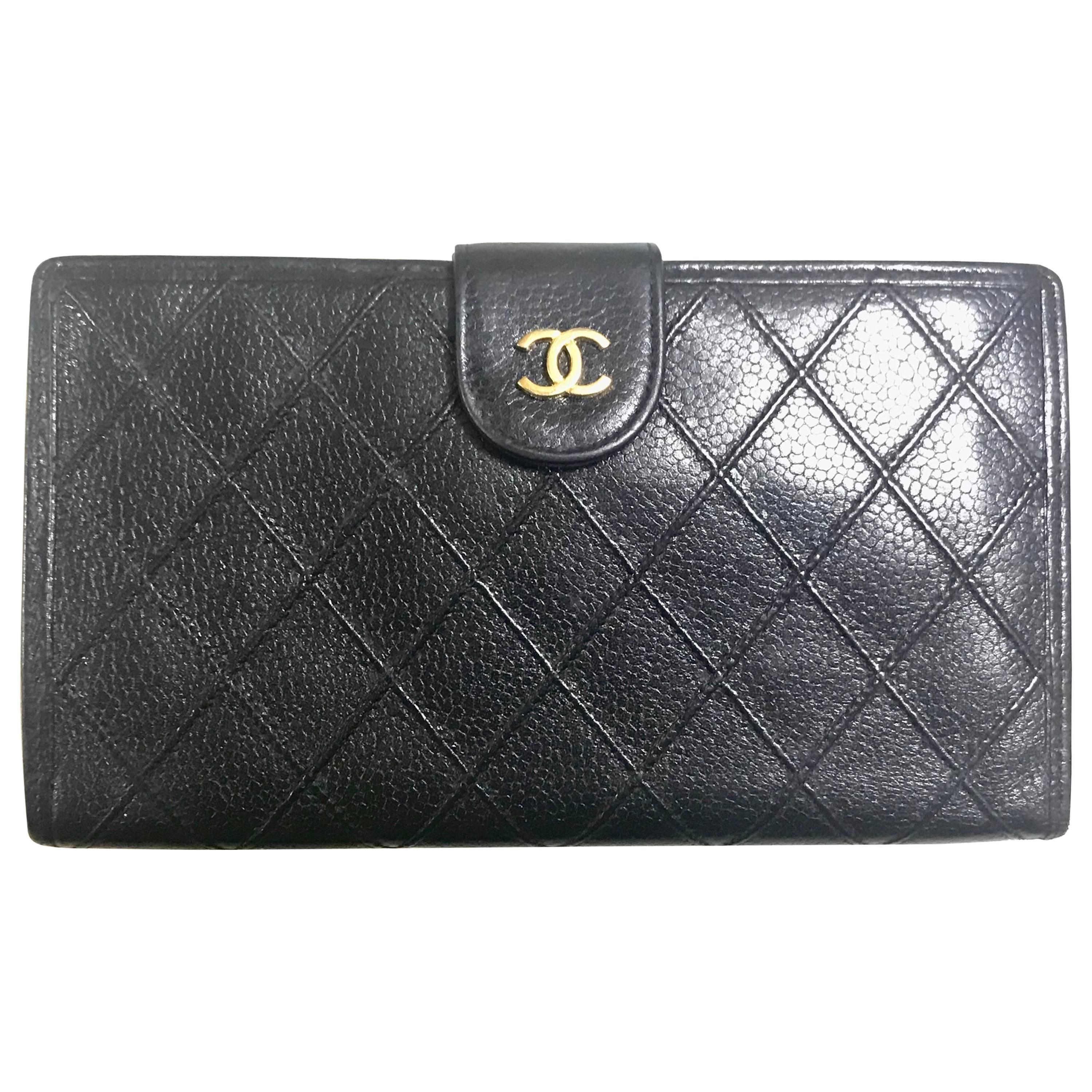 Vintage CHANEL black caviar leather wallet with stitches and gold tone CC motif. For Sale