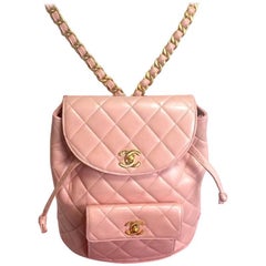 Vintage CHANEL quilted pink lamb backpack with golden CC and chain straps.