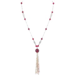 Art Deco cranberry glass and pearl sautoir, with unmarked silver links. 