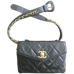 Vintage CHANEL black lamb waist bag, fanny pack with golden chain belt and CC.