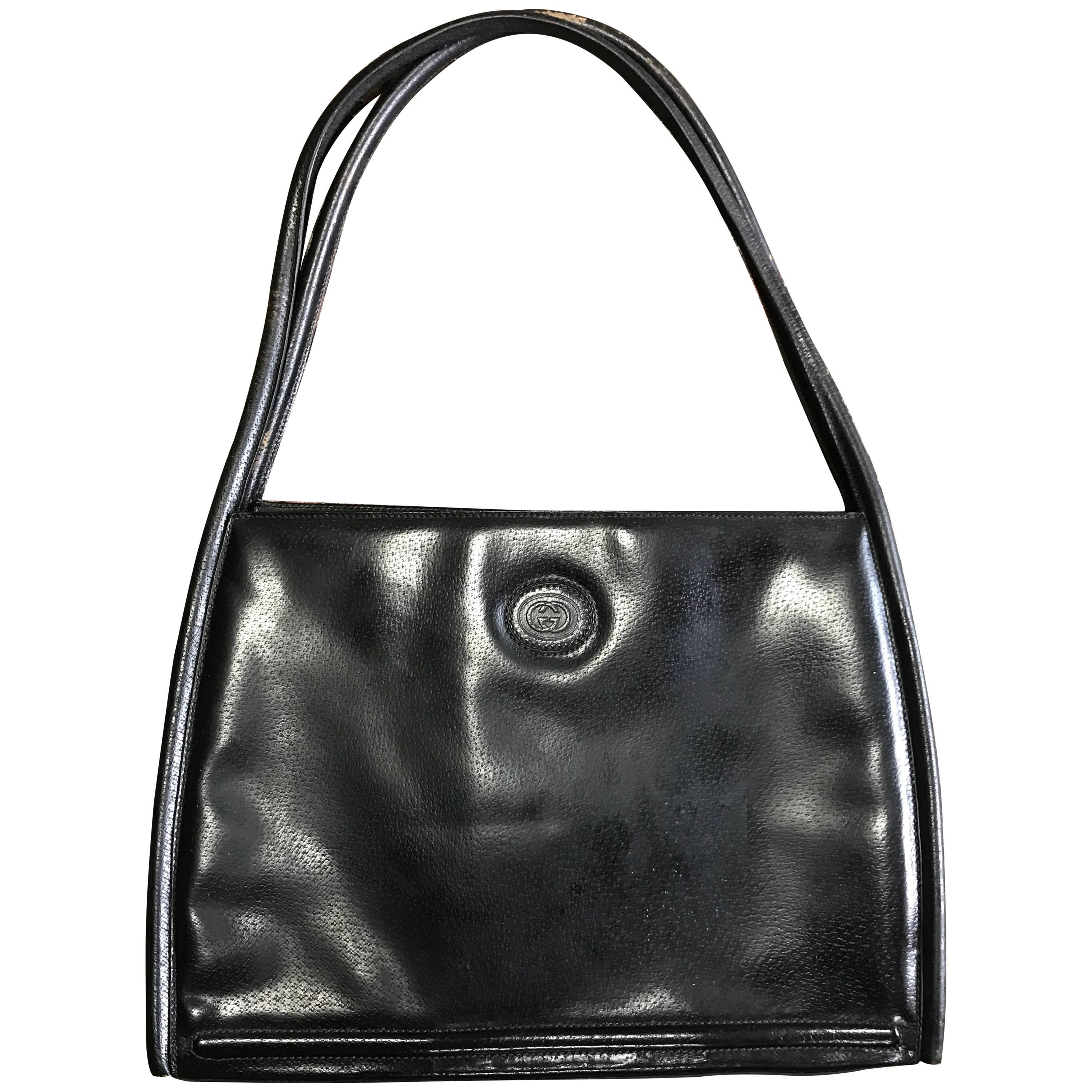 Vintage Gucci black pigskin large trapezoid shape shoulder bag with embossed GG. For Sale