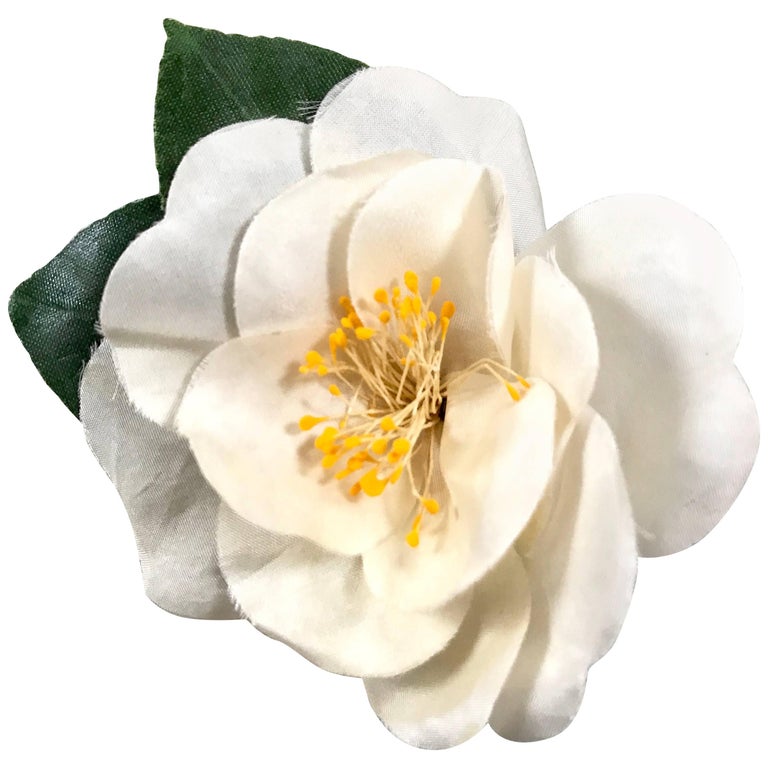 Vintage CHANEL ivory white silk camellia flower brooch with green leaves.  at 1stDibs