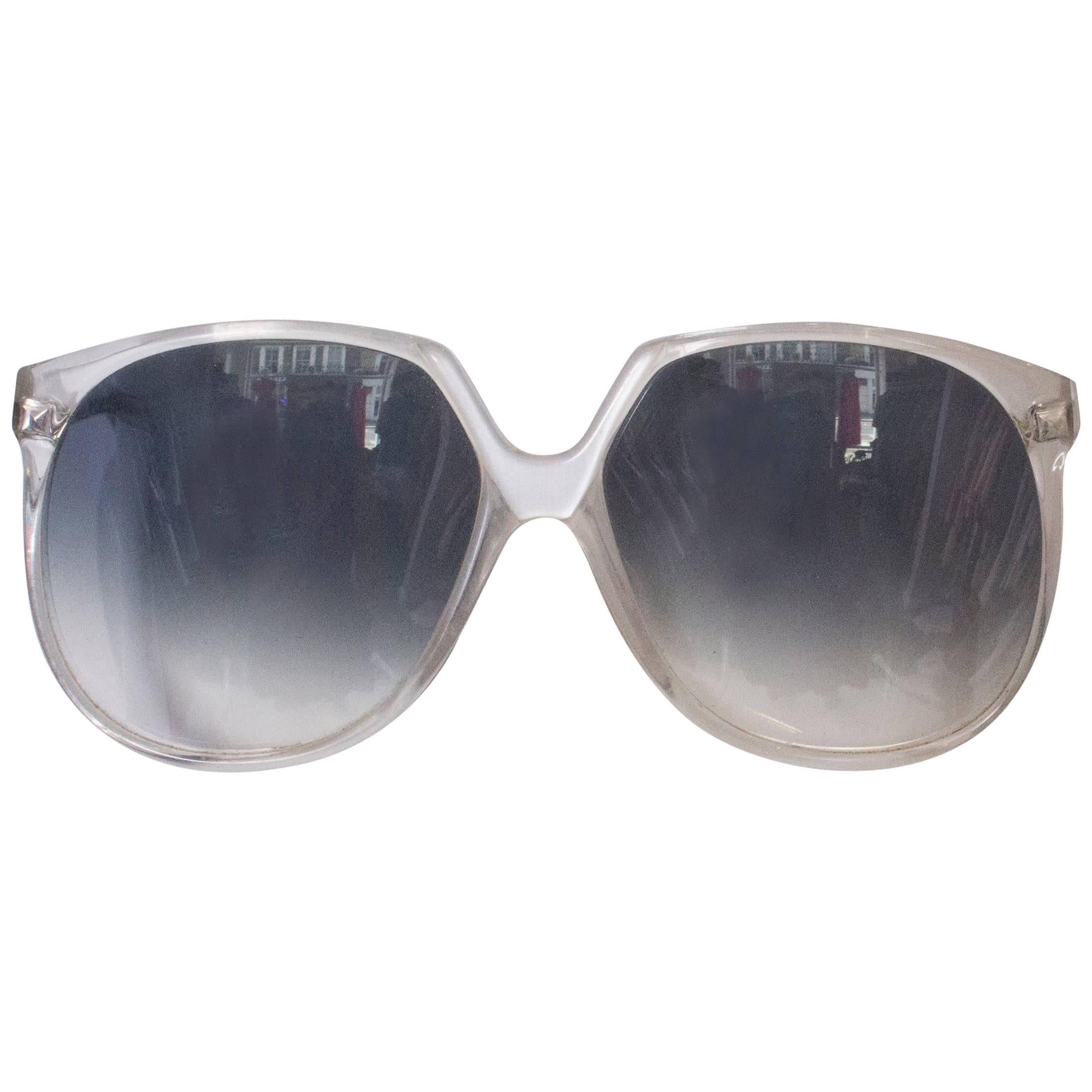 A pair of Vintage 1970s Sunglasses with White Frames