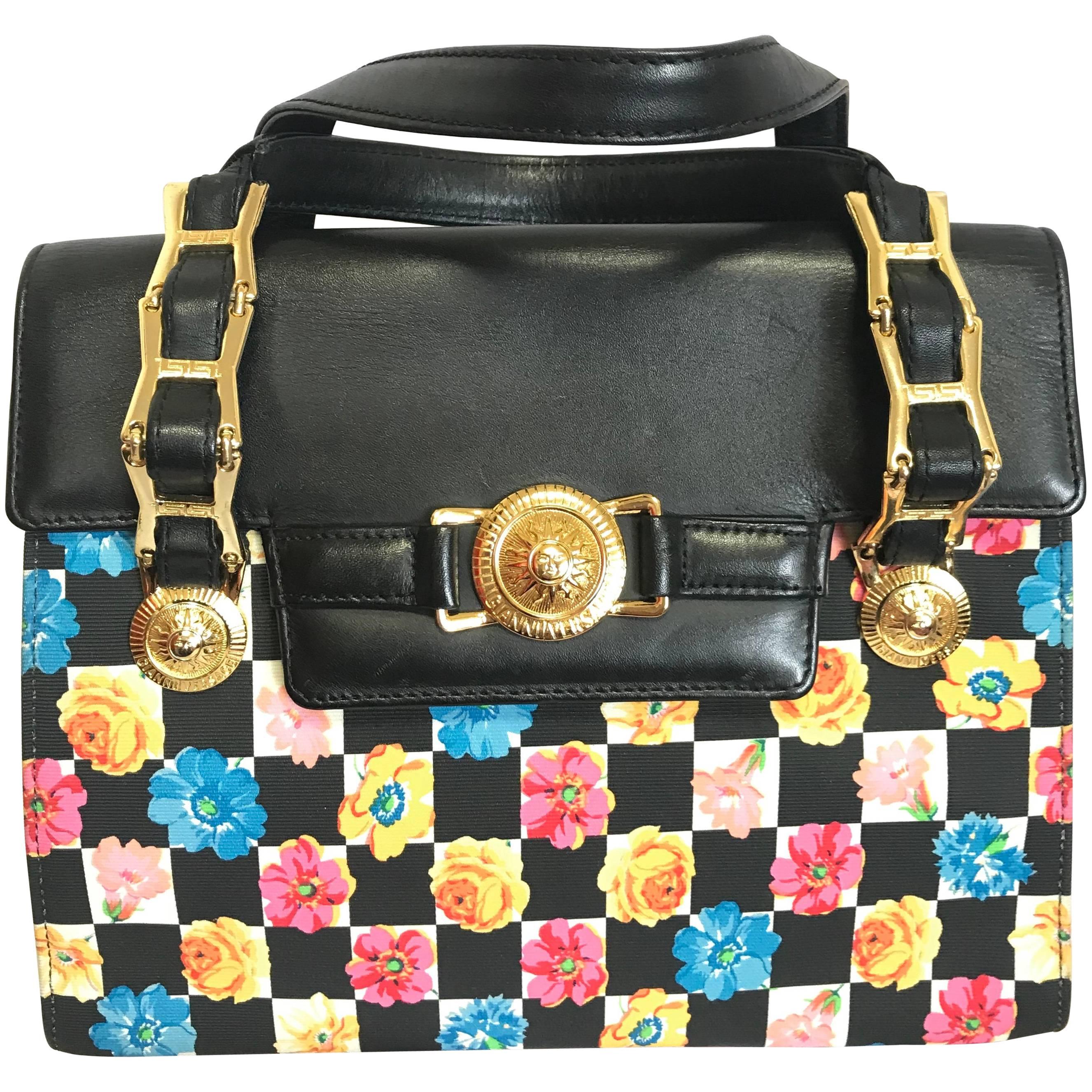 Vintage Gianni Versace black leather and pink, orange, and blue flower prints. For Sale