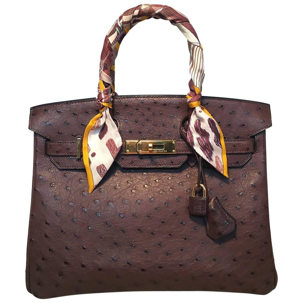 STUNNING Hermes Brown Ostrich 30cm Birkin Bag in excellent condition. Brown ostrich leather exterior trimmed with gold hardware and matching ostrich clochette with gold keys and lock. Signature twist double strap flap closure opens to a brown