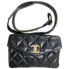Vintage CHANEL dark navy lamb leather waist bag, fanny pack with golden chains.
