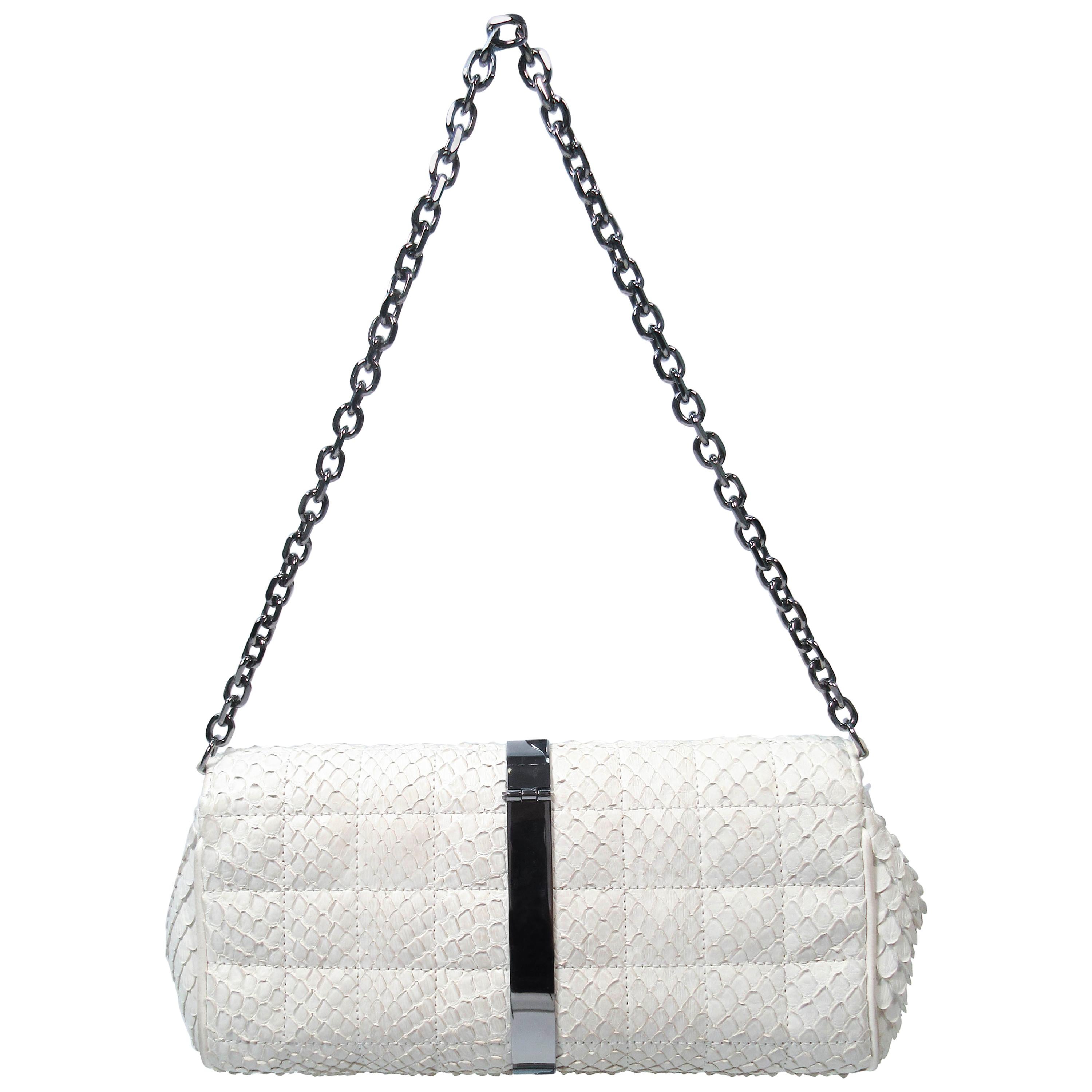 This Chanel purse is composed of white snakeskin. Features silver metal hardware with box and dustbag. In excellent pre-owned condition (some signs of wear due to age, see photos). Sold in 