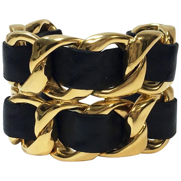 CHANEL Collector Cuff Bracelet in Gilt Metal Interlaced with Black Leather