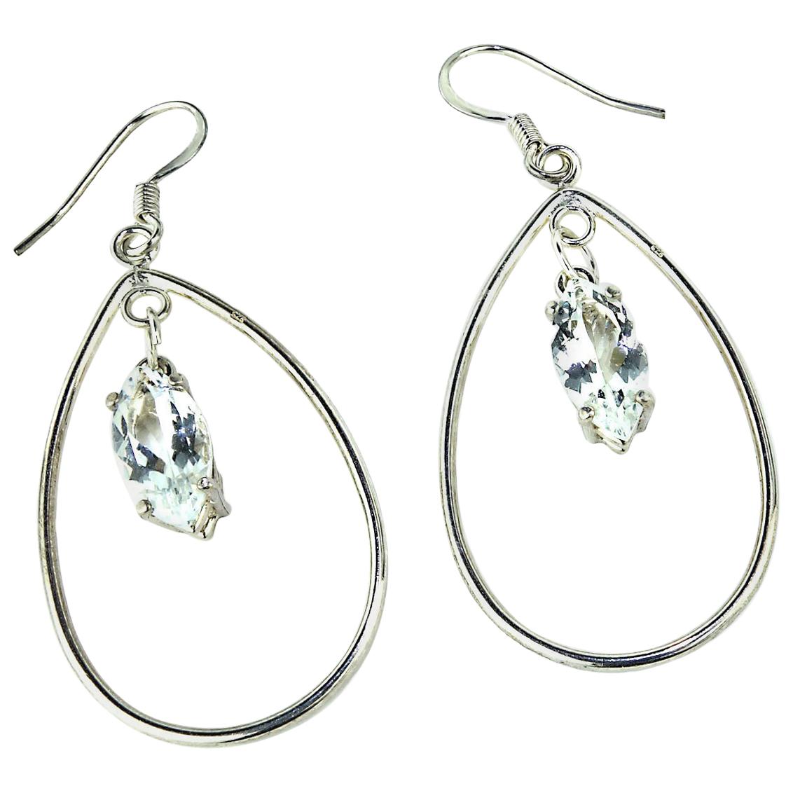 Earrings of Sterling Silver Teardrop hoops with a transparent marquise shaped Sri Lankan spinel dangling in the middle. These earrings have lots of swing and movement and the transparent spinel flash and sparkle. The earrings have silver plate