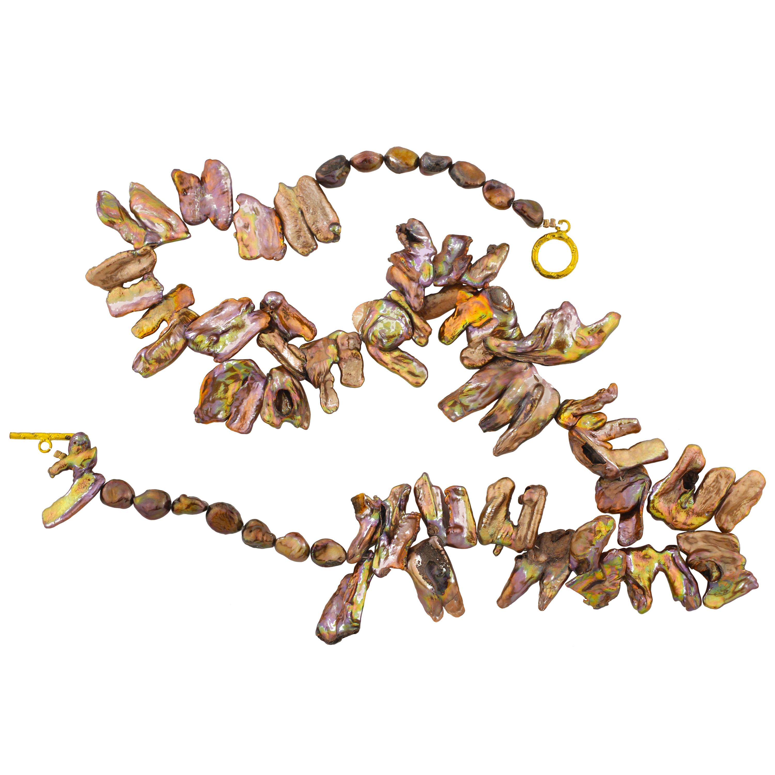 Brilliant color reflecting petals of copper pearls you can flip flop in two different directions on this fascinating handmade necklace that is 22 inches long.  The artistry in the design is intrinsic in the Pearls.  The clasp is a goldish tone.  